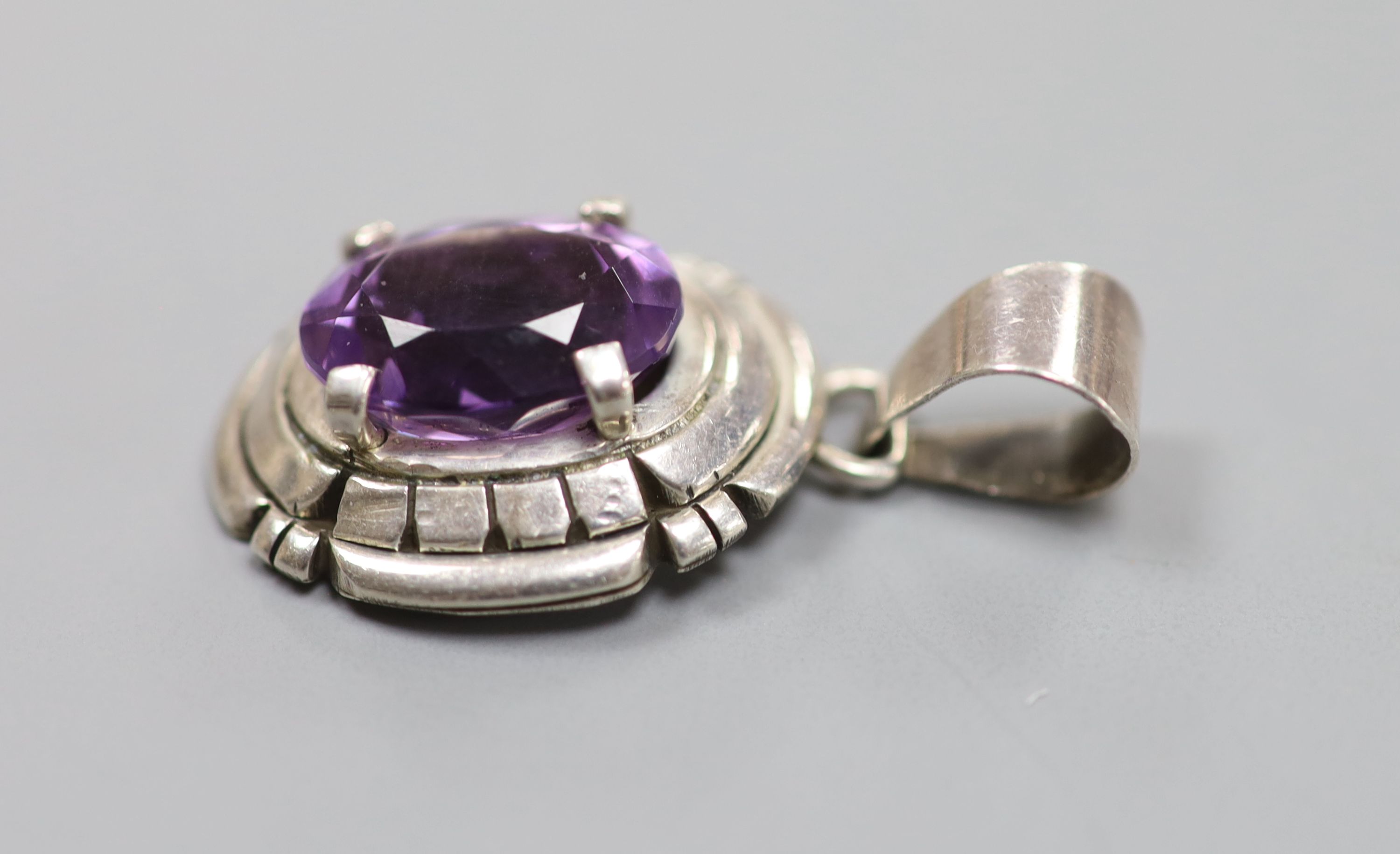 A continental sterling and amethyst set oval pendant, signed Carl Quintana